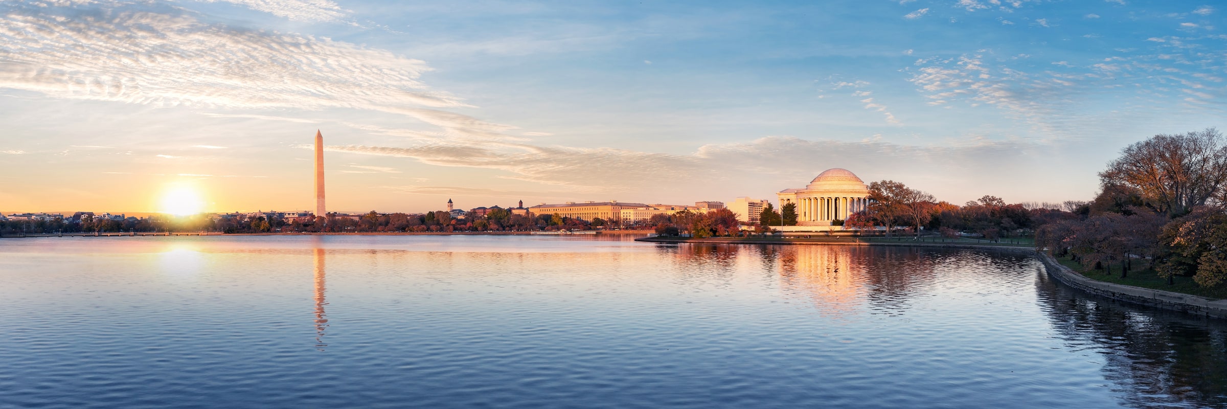 Sunrise over the Tidal Basin in Washington, DC, with the Washington Monument and the Jefferson Memorial on the skyline